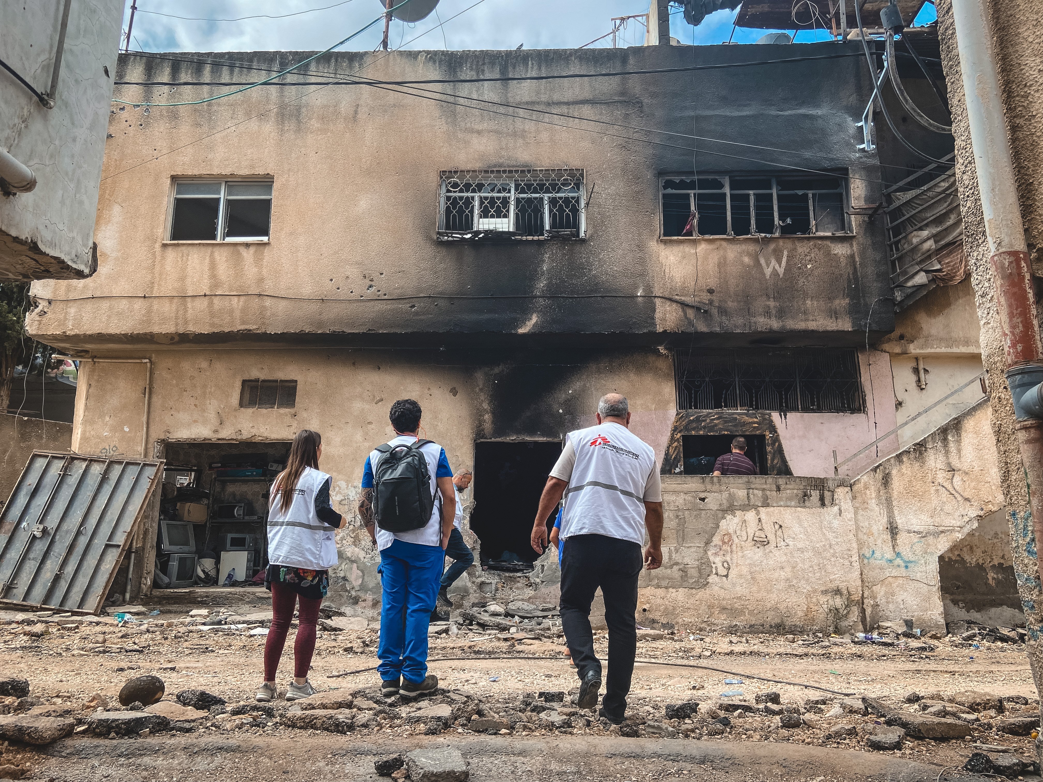 MSF team in front of bombed building in Jenin