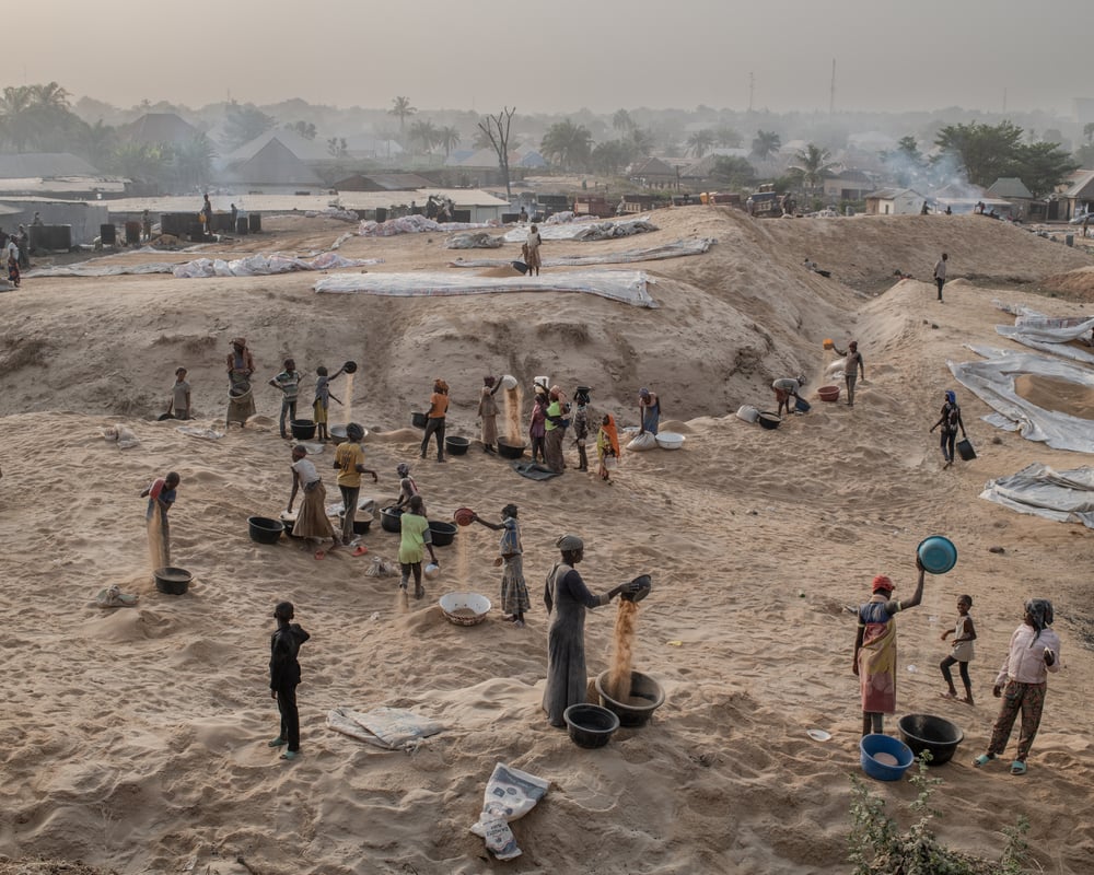 People work in a rice mill located at the entrance to Makurdi town