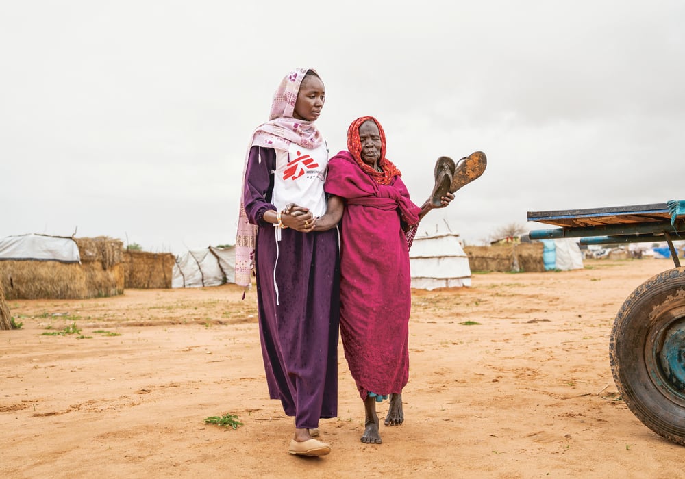 Health promoter accompanies patient to an MSF clinic in eastern Chad