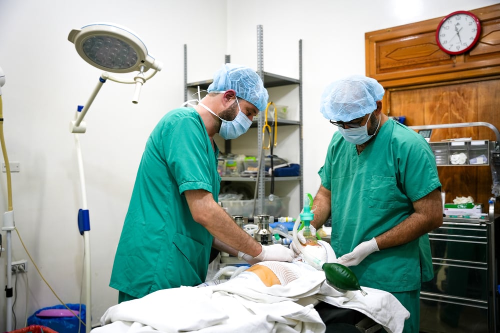 Nurses in the Atmeh Burns Unit prepare a child to transfer from the operating room after surgery
