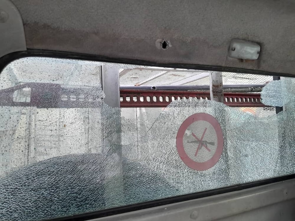 Shattered windscreen and gunshot hole