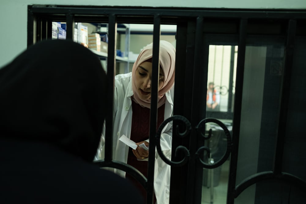 Health worker distributes medication