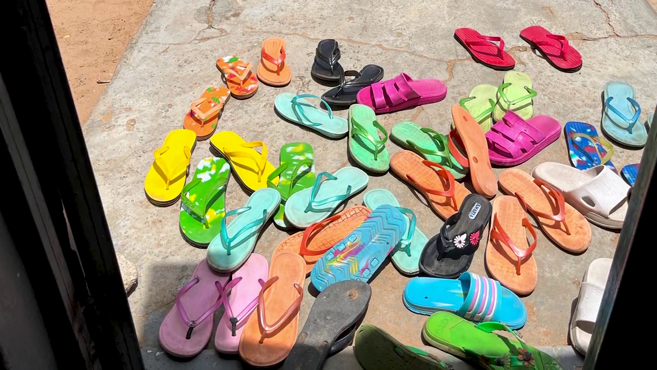 Multi-coloured footwear of fistula patients at the entrance to a rehabilitation exercise room in MSF's Jahun project, northern Nigeria © MSF