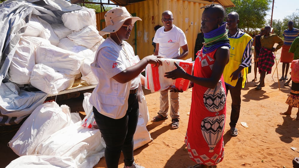A MSF environmental health manager distributes insecticide-treated nets