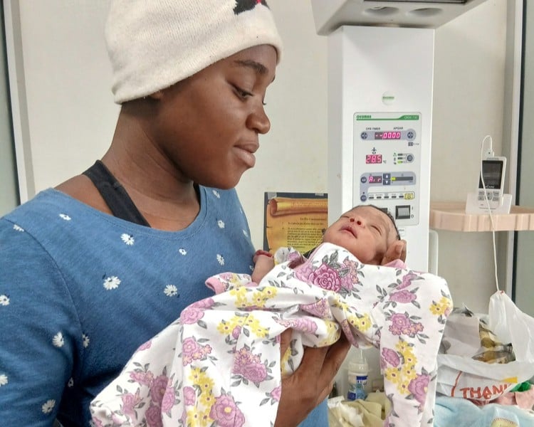 Sterline holds her newborn daughter