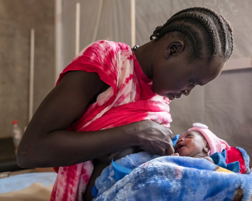 Mother breastfeeds baby for the first time