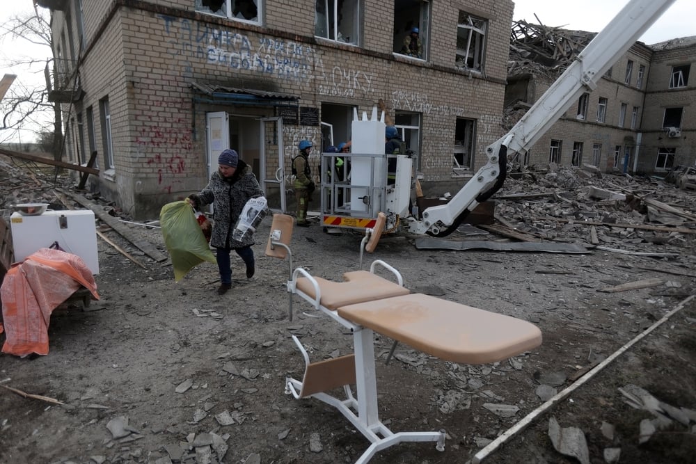 Medical staff evacuate medical equipment from a maternity hospital destroyed by a Russian missile attack