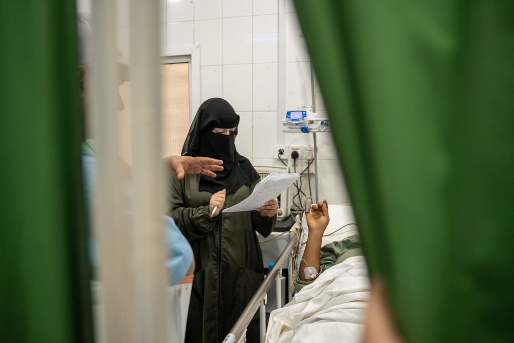  A doctor checks on patients in the intensive care unit