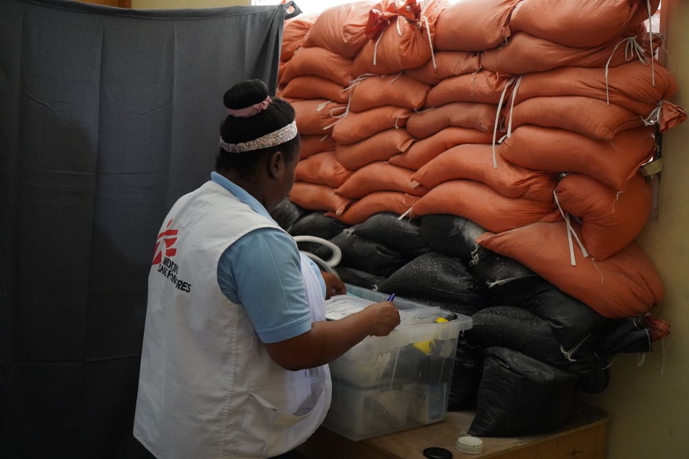 An MSF midwife checks medicines for distribution