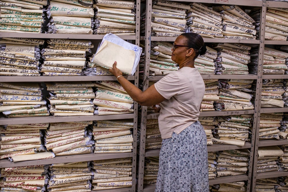 A staff member checks a medical file
