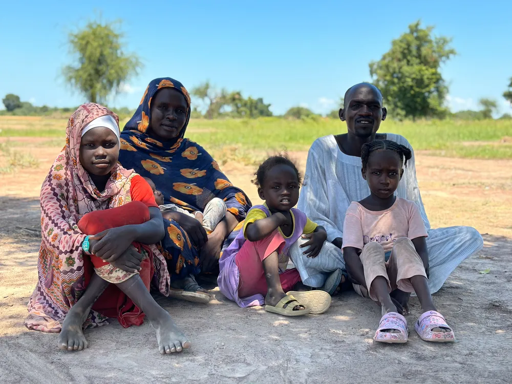 Family sitting at Wedweil refugee settlement
