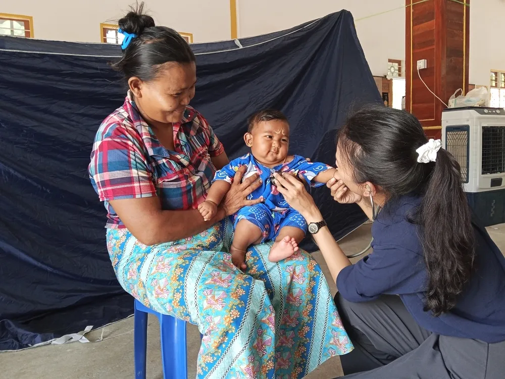 Mother and child examined by doctor