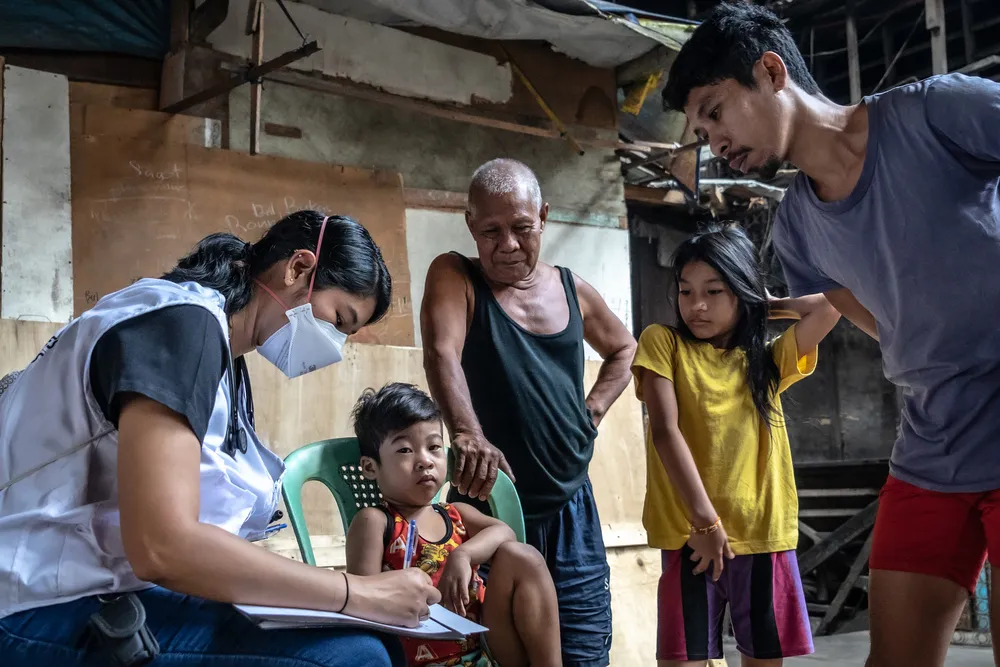 A doctor assesses the health condition of a child in Tondo, Manila