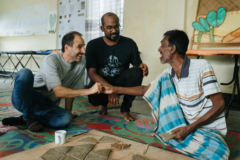 Former MSF international president Christos Christou (left) and Arunn Jegan (centre) with Rohingya ceramicist Kali Kumar Rudro