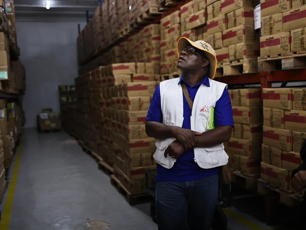 MSF project coordinator Huggins Madondo inspects the ready-to-use therapeutic food