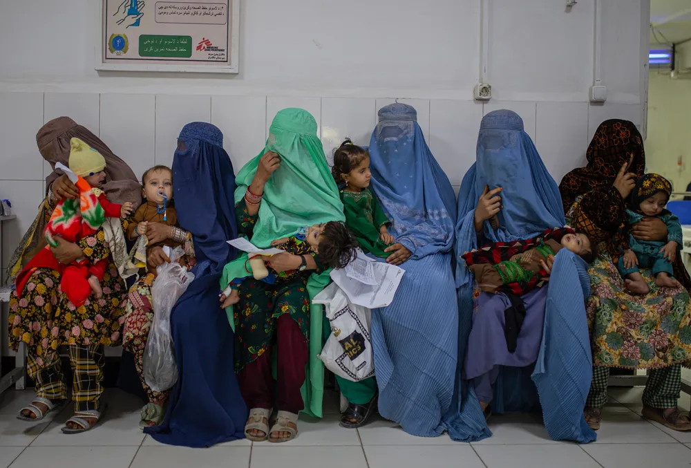 Mothers wait in the emergency department with their sick children