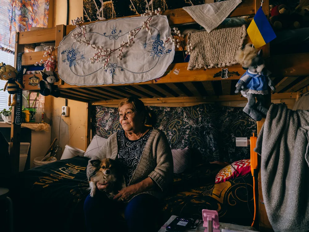Zinaida hugs her dog, Toshyk, in a shelter in Dnipro