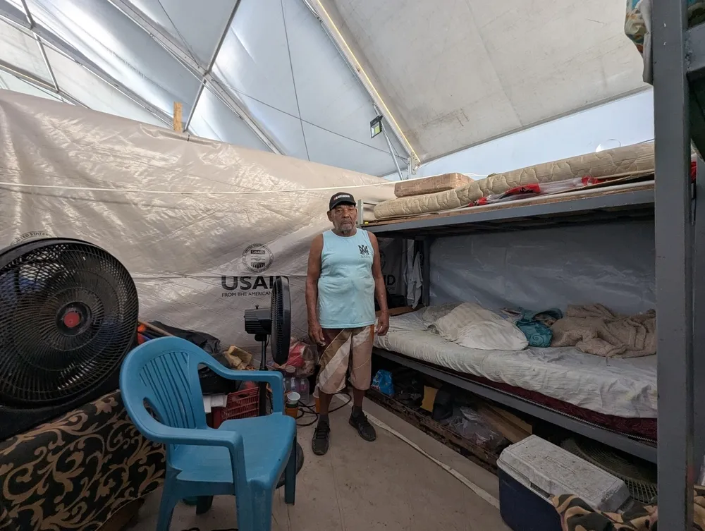 Seventy-seven-year-old survivor Juan Martínez stands in a temporary tent