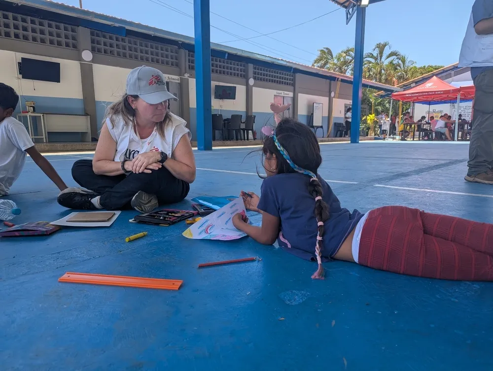 MSF mental health activity manager Carolina López guides a child through a psychoeducation session