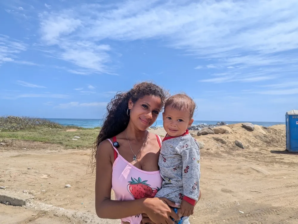 Twenty-one-year-old survivor Hellen holds her one-year-old son, César