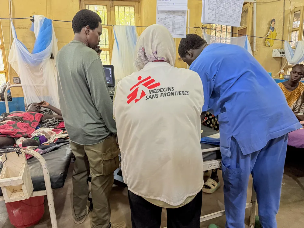 Doctors attend to a young woman who lost her baby