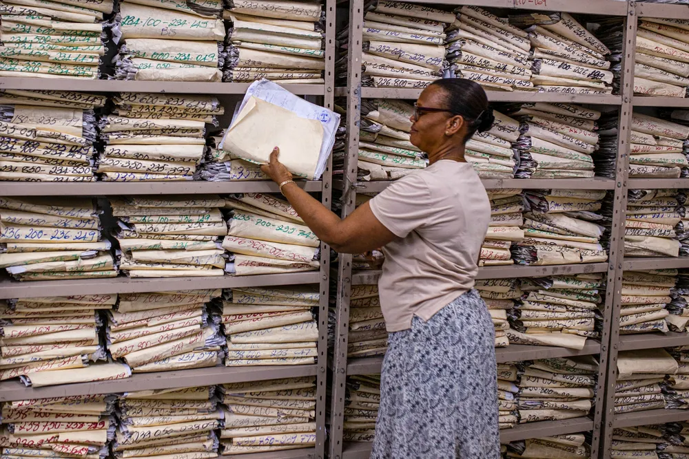 A staff member checks a medical file