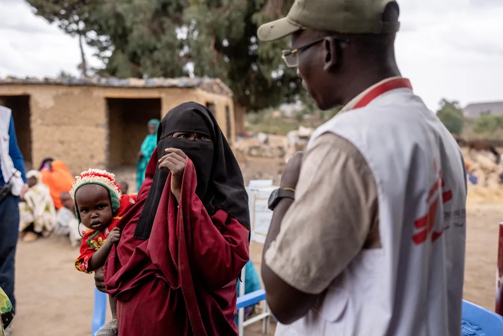 An MSF health promoter engages with a community member
