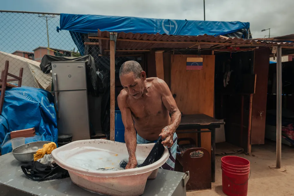 Hector Garcia, 75, washes his clothes