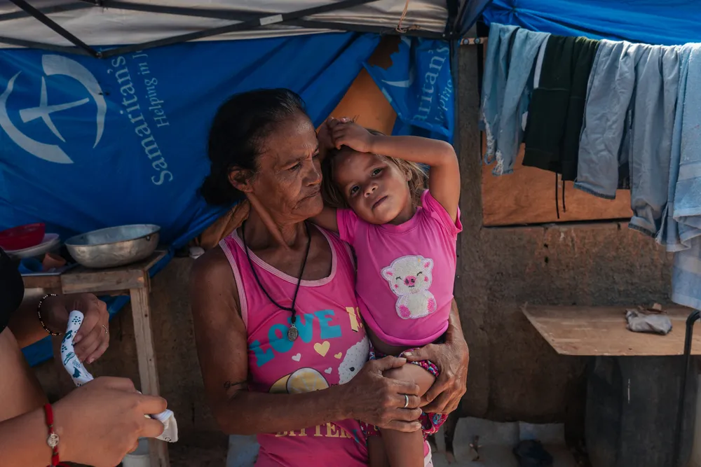 Milaidy Mateus, 59, holds three-year-old Ashley