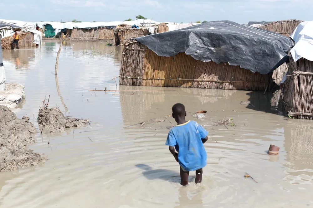 A boy walks through floodwater in the United Nations Protection of Civilians compound in Bentiu, South Sudan.