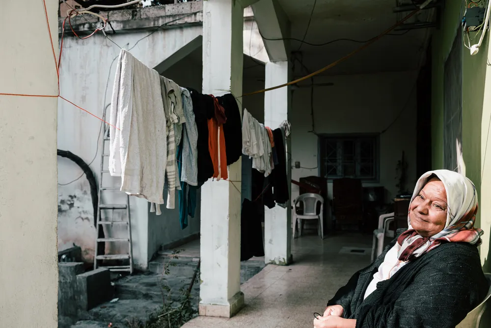 Fatima, 58, in front of her in-laws' house, where she shares a room with her husband and daughter. Fatima suffers from severe complications due to diabetes. © Karine Pierre/Hans Lucas/MSF