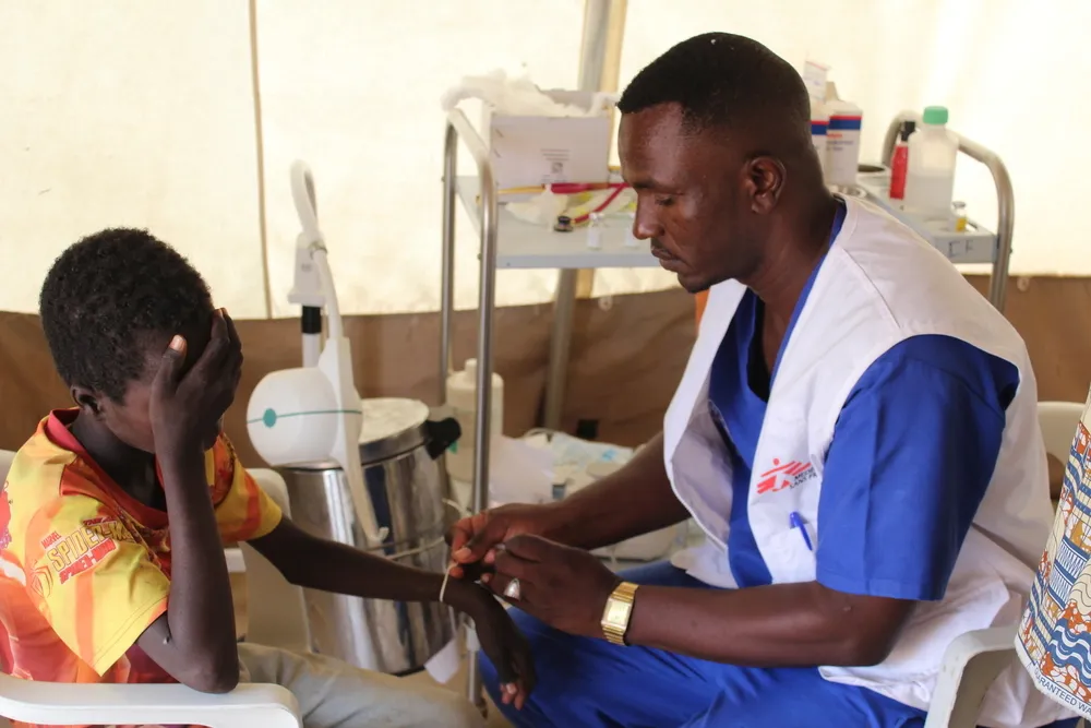 A nurse attends to a patient in the ER department at the MSF clinic in Zamzam Camp, North Darfur.
