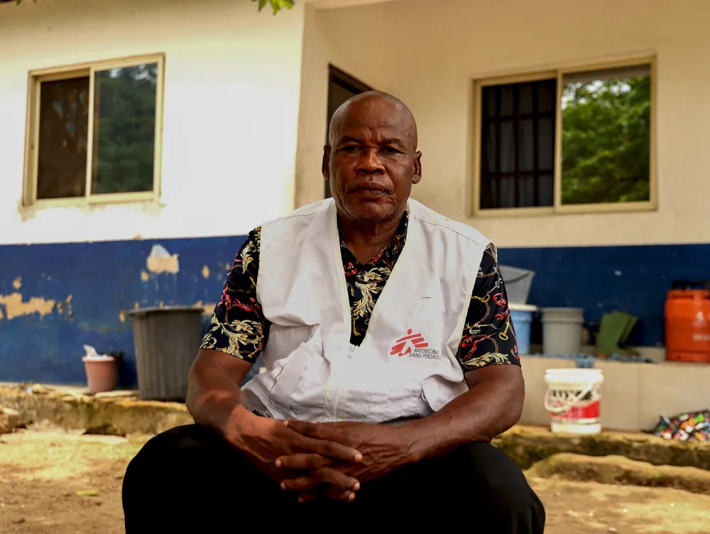 MSF driver Patrick A.Njok sits under a tree after driving through the long journey on a difficult terrain