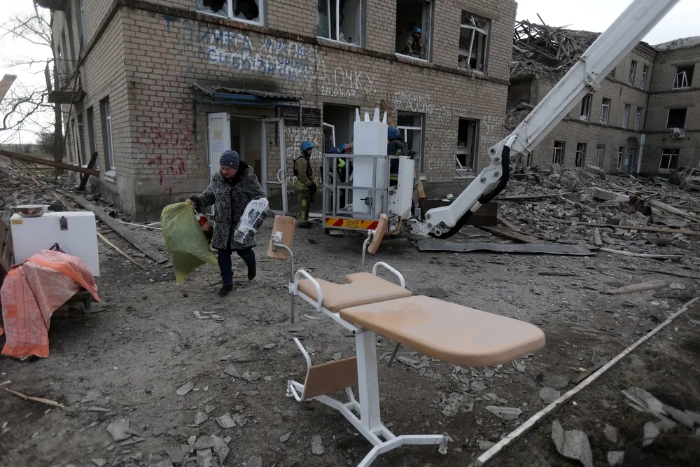 Medical staff evacuate medical equipment from a maternity hospital destroyed by a Russian missile attack