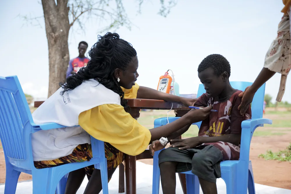 MSF nurse examining 9 year old