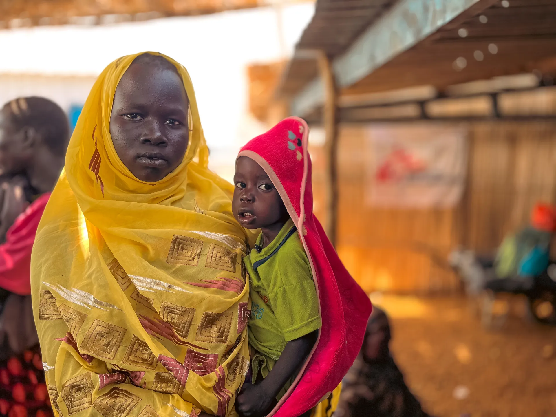 Mother ds her new baby in front of MSF hospital in Wad Madani
