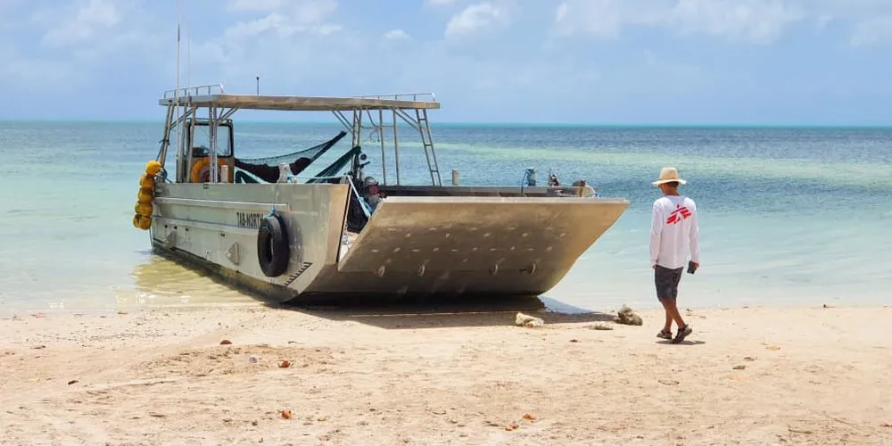 Logistics coordinator Thomas Hing looks at a boat, Tab North, Kiribati