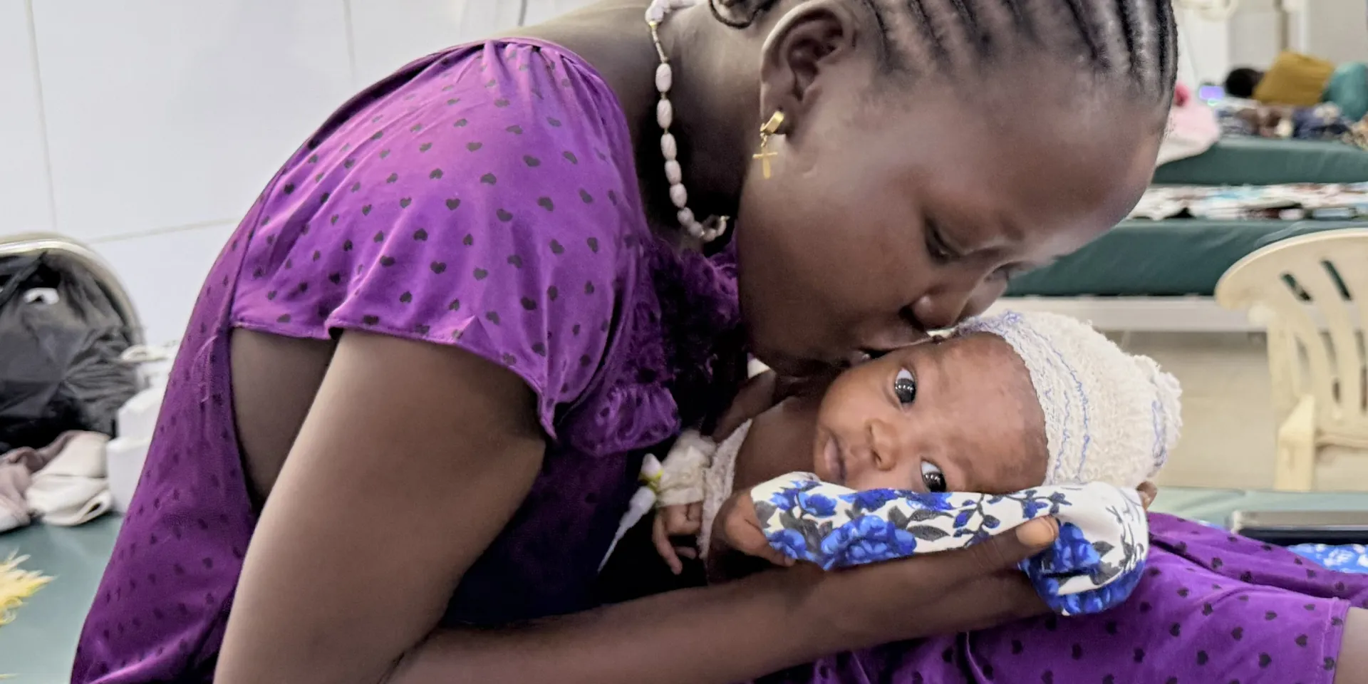 Abuk kisses her newborn son