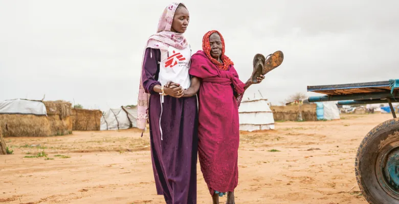 Health promoter accompanies patient to an MSF clinic in eastern Chad