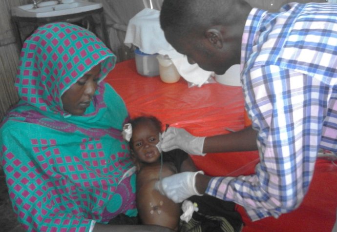 White Nile State, Sudan, Doctor examines child